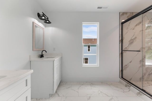 274A W Main St, Dandridge, TN 37725 - bathroom featuring two vanities, a marble finish shower, marble look tiles, and baseboards