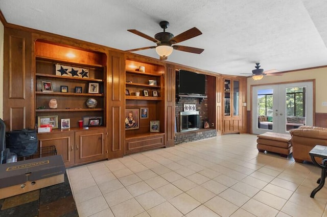 591 Phyllis Cir, Talbott, TN 37877 - living room with a textured ceiling, ceiling fan, french doors, a fireplace, and light tile patterned flooring
