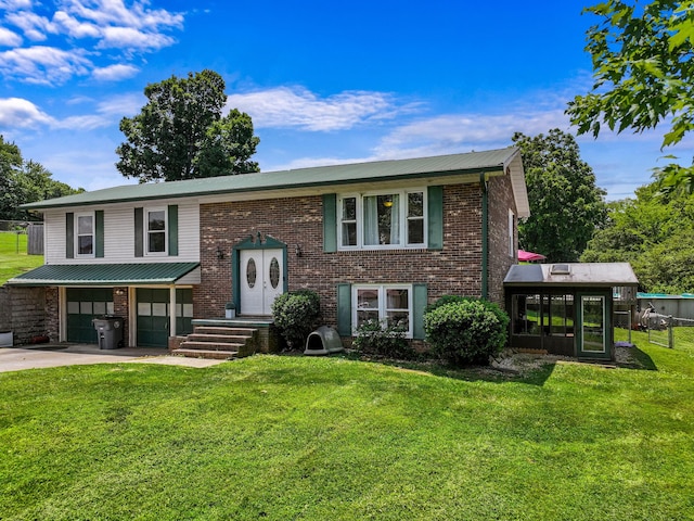 591 Phyllis Cir, Talbott, TN 37877 - bi-level home featuring a garage, a front yard, brick siding, and concrete driveway