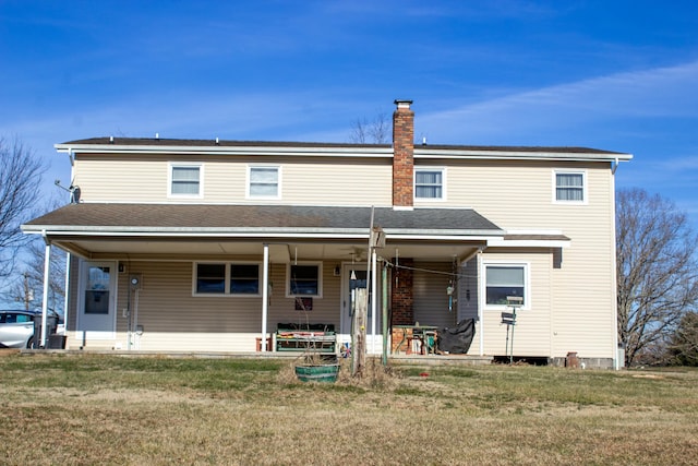 rear view of house with a lawn