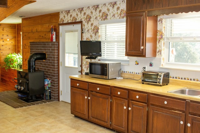 kitchen with sink and a wood stove