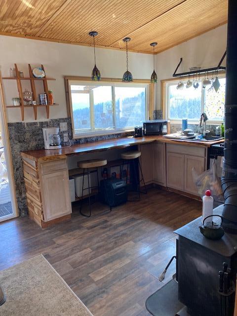 kitchen featuring wood ceiling, dark wood-style floors, and black microwave