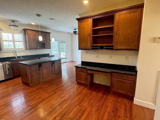 kitchen featuring a center island, hanging light fixtures, stainless steel dishwasher, ceiling fan, and a textured ceiling