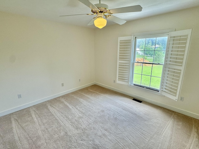 spare room featuring ceiling fan and carpet floors