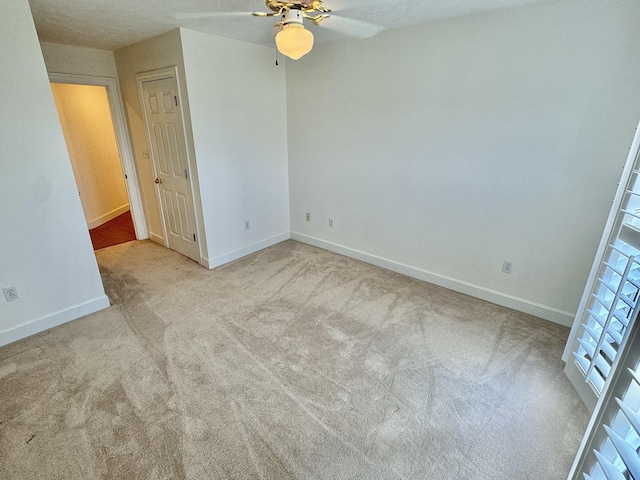 unfurnished bedroom with light carpet and ceiling fan