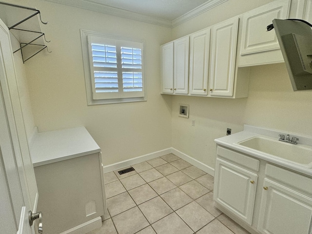 washroom with sink, cabinets, washer hookup, light tile patterned flooring, and ornamental molding