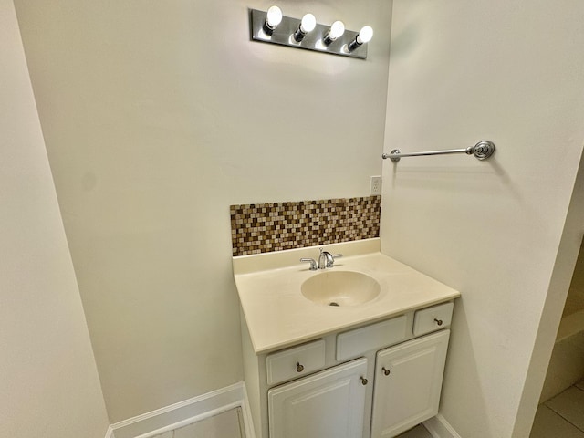 bathroom featuring tasteful backsplash and vanity