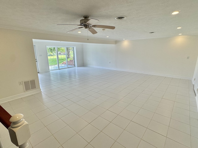 tiled spare room featuring ceiling fan, a textured ceiling, and ornamental molding