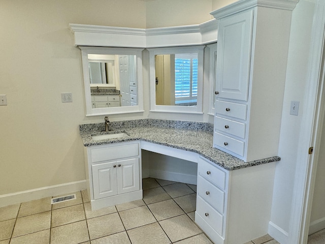 bathroom with tile patterned floors and vanity