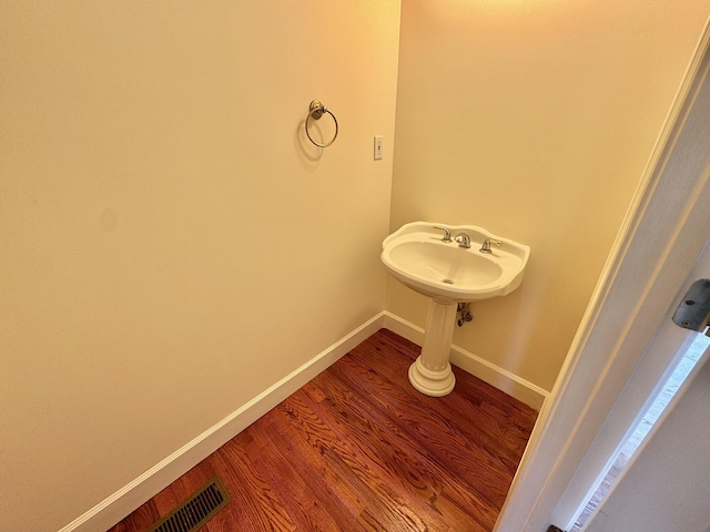 bathroom with sink and wood-type flooring