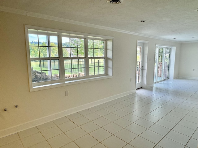 tiled spare room with a textured ceiling and ornamental molding