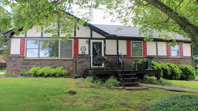 2925 Lake Forest Cir, Talbott, TN 37877 - tudor house featuring brick siding, a wooden deck, and a front lawn