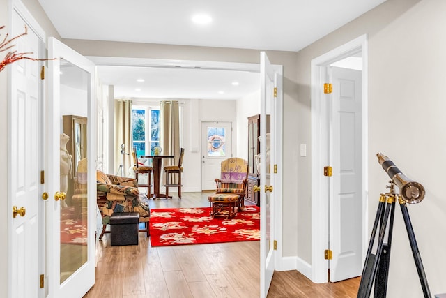 corridor featuring light hardwood / wood-style flooring and french doors