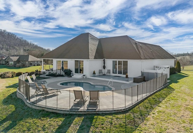 view of swimming pool with a lawn and a patio