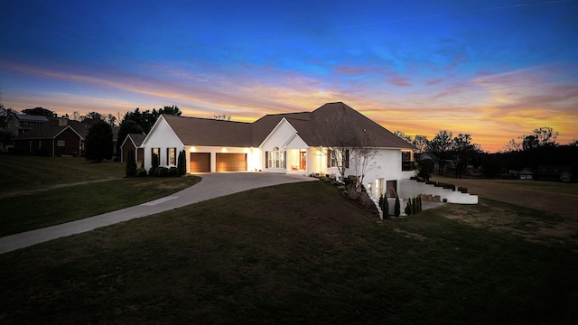 view of front of house featuring a yard and a garage