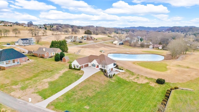birds eye view of property featuring a water and mountain view