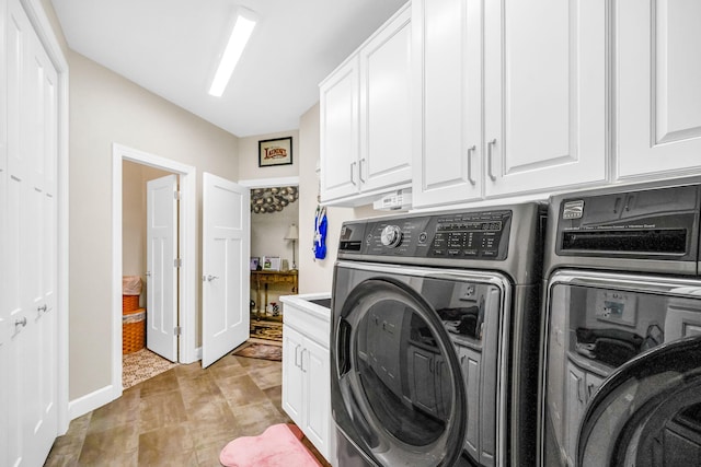 laundry area featuring cabinets and washing machine and clothes dryer