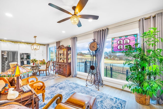 living room featuring ceiling fan and light hardwood / wood-style flooring
