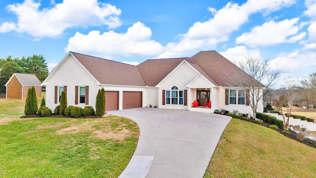 view of front of house featuring a garage and a front lawn