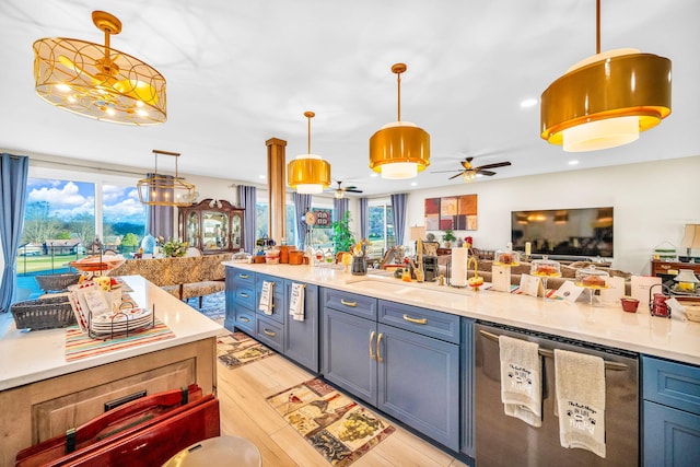 kitchen with pendant lighting, dishwasher, sink, ceiling fan, and light hardwood / wood-style floors