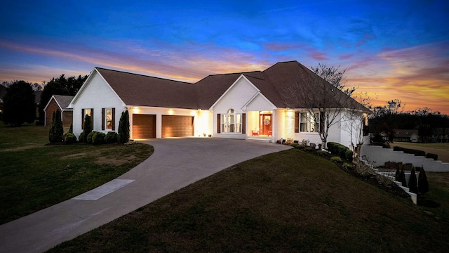 view of front facade featuring a lawn and a garage