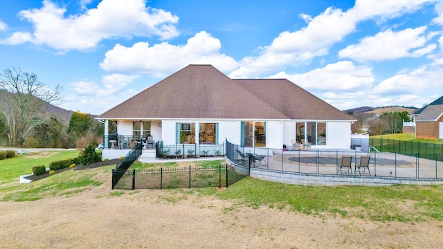 rear view of house featuring a lawn and a mountain view