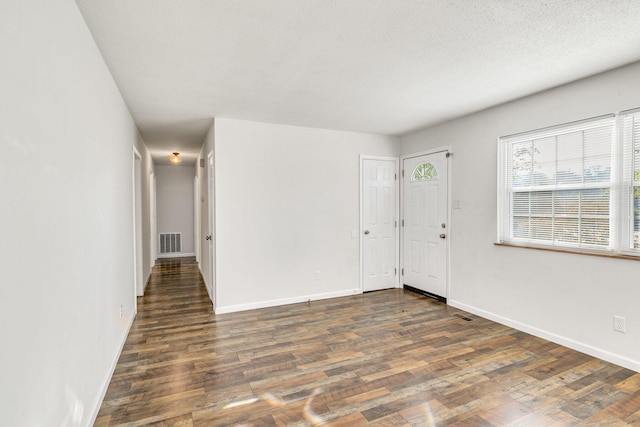 spare room featuring dark hardwood / wood-style flooring