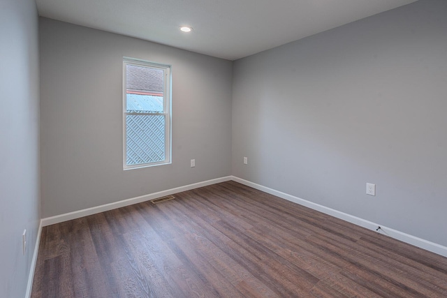 spare room with dark hardwood / wood-style floors