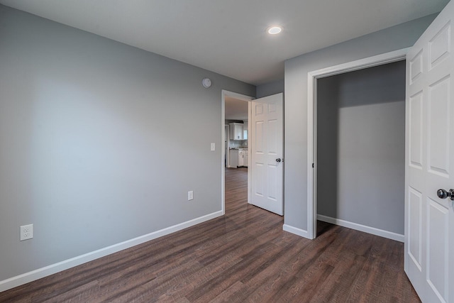 unfurnished bedroom featuring dark hardwood / wood-style flooring