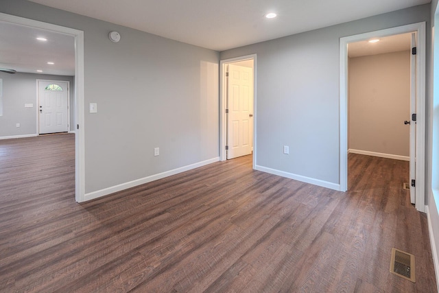 empty room featuring dark hardwood / wood-style flooring