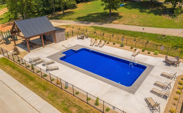 pool featuring fence, a lawn, a gazebo, and a patio area