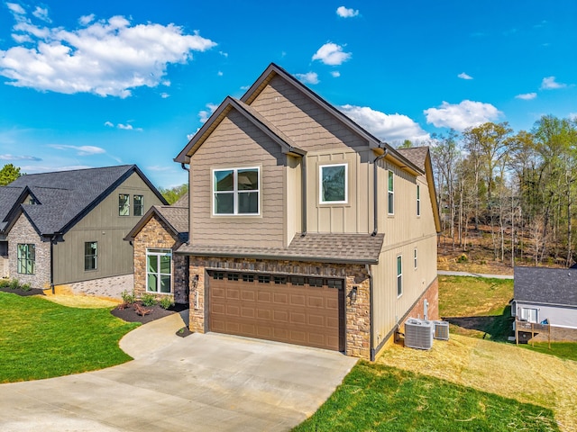 view of front of house with central AC unit, driveway, stone siding, board and batten siding, and an attached garage