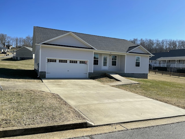 ranch-style house featuring a garage and a front lawn