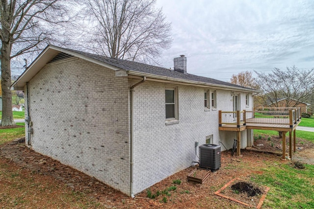 506 Viola Cir, Mount Carmel, TN 37645 - view of property exterior with brick siding, central AC unit, a deck, and a chimney