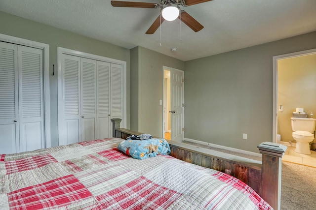 506 Viola Cir, Mount Carmel, TN 37645 - bedroom with carpet floors, a textured ceiling, ensuite bathroom, two closets, and ceiling fan