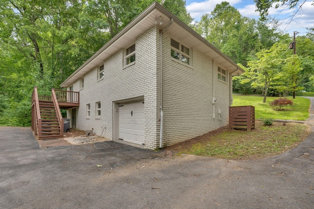 2306 Mountain Dr, Kingsport, TN 37664 - view of side of property with stairway, a garage, a wooden deck, driveway, and brick siding