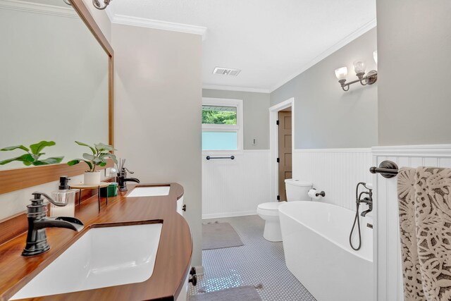 2306 Mountain Dr, Kingsport, TN 37664 - bathroom with a soaking tub, a wainscoted wall, toilet, double vanity, and ornamental molding