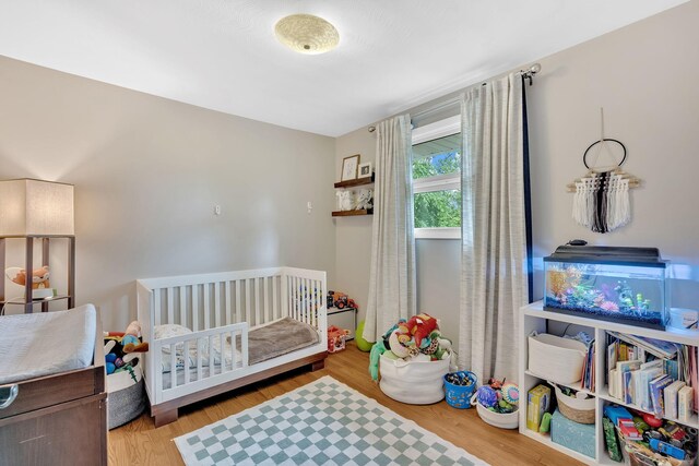 2306 Mountain Dr, Kingsport, TN 37664 - bedroom featuring a crib and wood finished floors