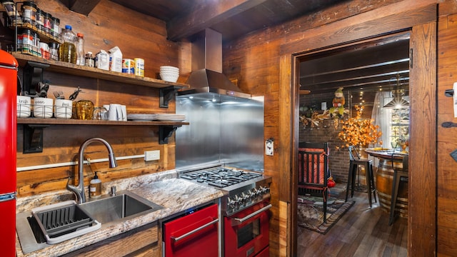 1131 Old Cartertown Rd, Gatlinburg, TN 37738 - kitchen with high end stove, wood finished floors, a sink, island exhaust hood, and wooden walls