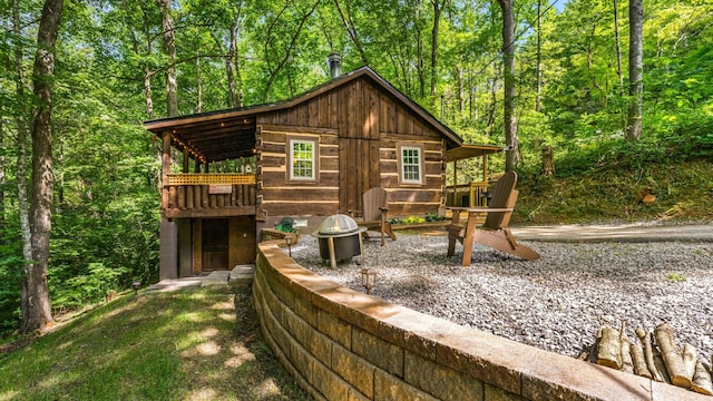 1131 Old Cartertown Rd, Gatlinburg, TN 37738 - view of outdoor structure featuring an outdoor fire pit and a forest view
