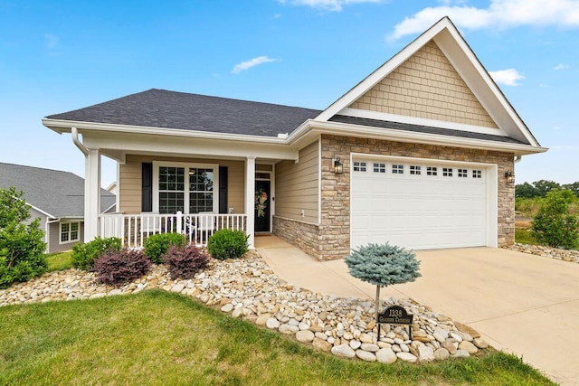 view of front of house featuring a porch, an attached garage, a shingled roof, stone siding, and driveway