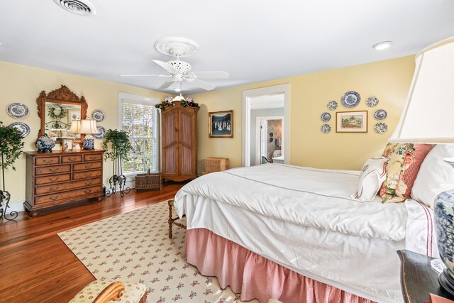 bedroom with ceiling fan and dark wood-type flooring