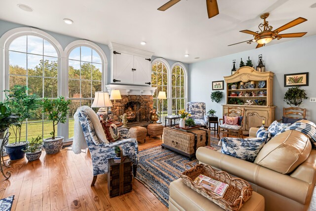 living room featuring hardwood / wood-style flooring and a stone fireplace