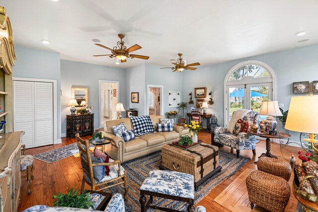 living room with ceiling fan, french doors, and wood-type flooring