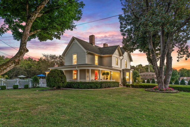 country-style home with a yard and a porch