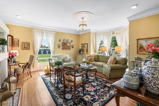 living room featuring wood-type flooring, a wealth of natural light, and a chandelier