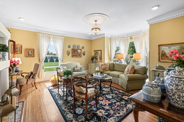 living room featuring wood-type flooring, a wealth of natural light, and a chandelier