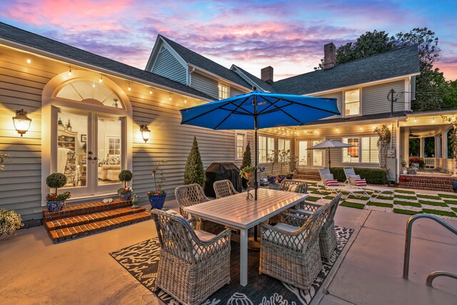 patio terrace at dusk featuring french doors