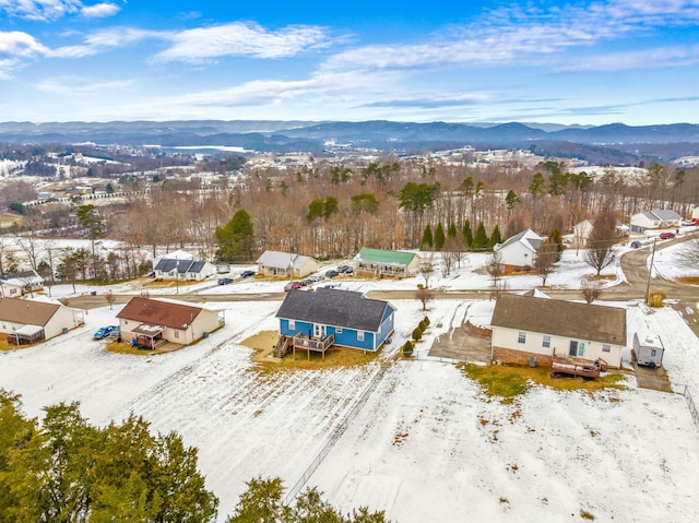 snowy aerial view with a mountain view