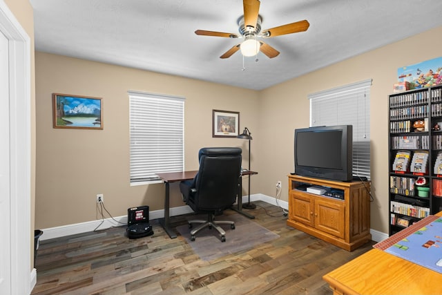 office featuring dark wood-type flooring and ceiling fan